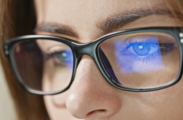 A-close-up-shot-of-a-womans-eyes-wearing-blue-light-glasses-that-reflect-a-blue-computer-screen-2-1024x672 1.56 Blue Cut SHMC Green Prescription Lenses – Screen & UV Protection